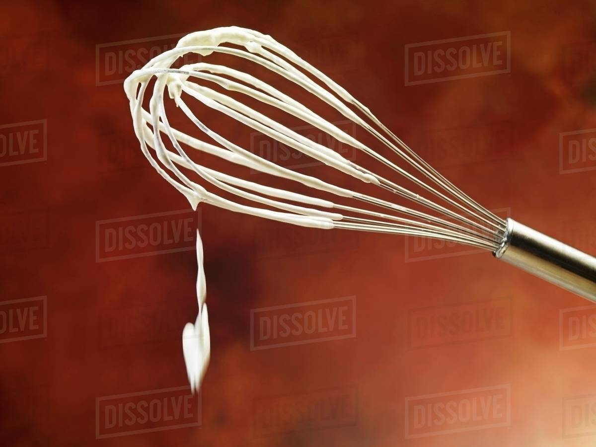A whisk with whipped cream Stock Photo Dissolve