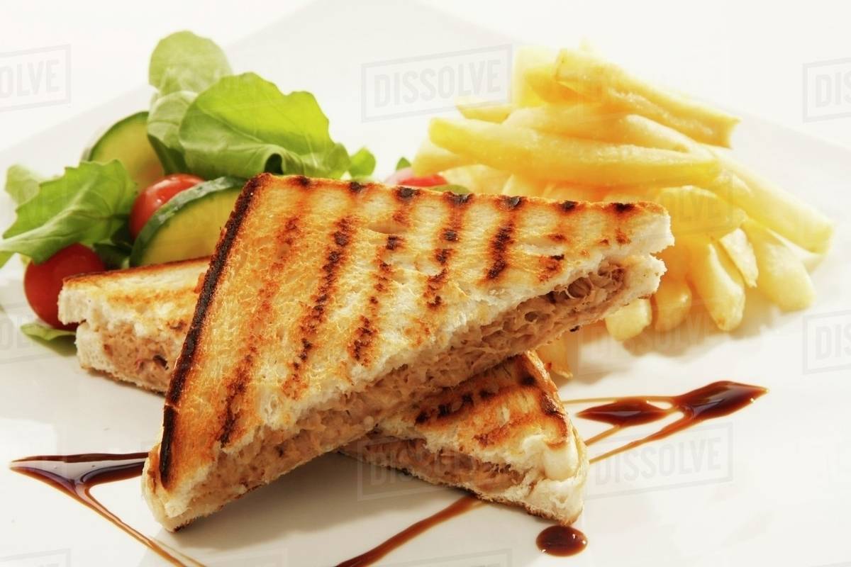 Toasted tuna sandwich with chips Stock Photo Dissolve