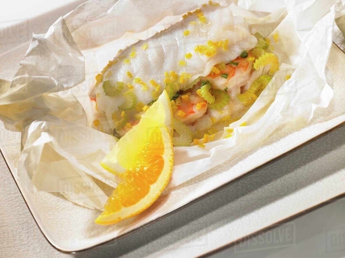 Saffron fish in parchment paper Stock Photo Dissolve