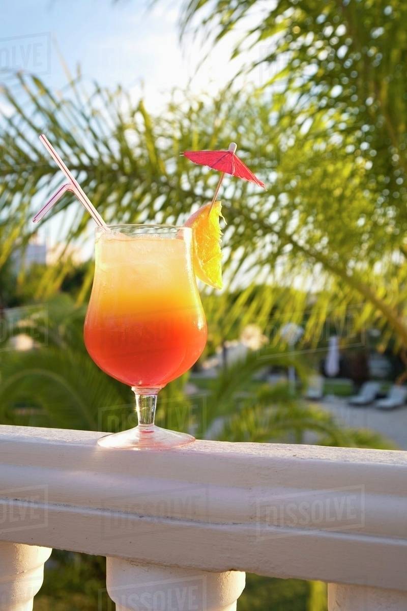 Cocktail on a balcony rail Stock Photo Dissolve