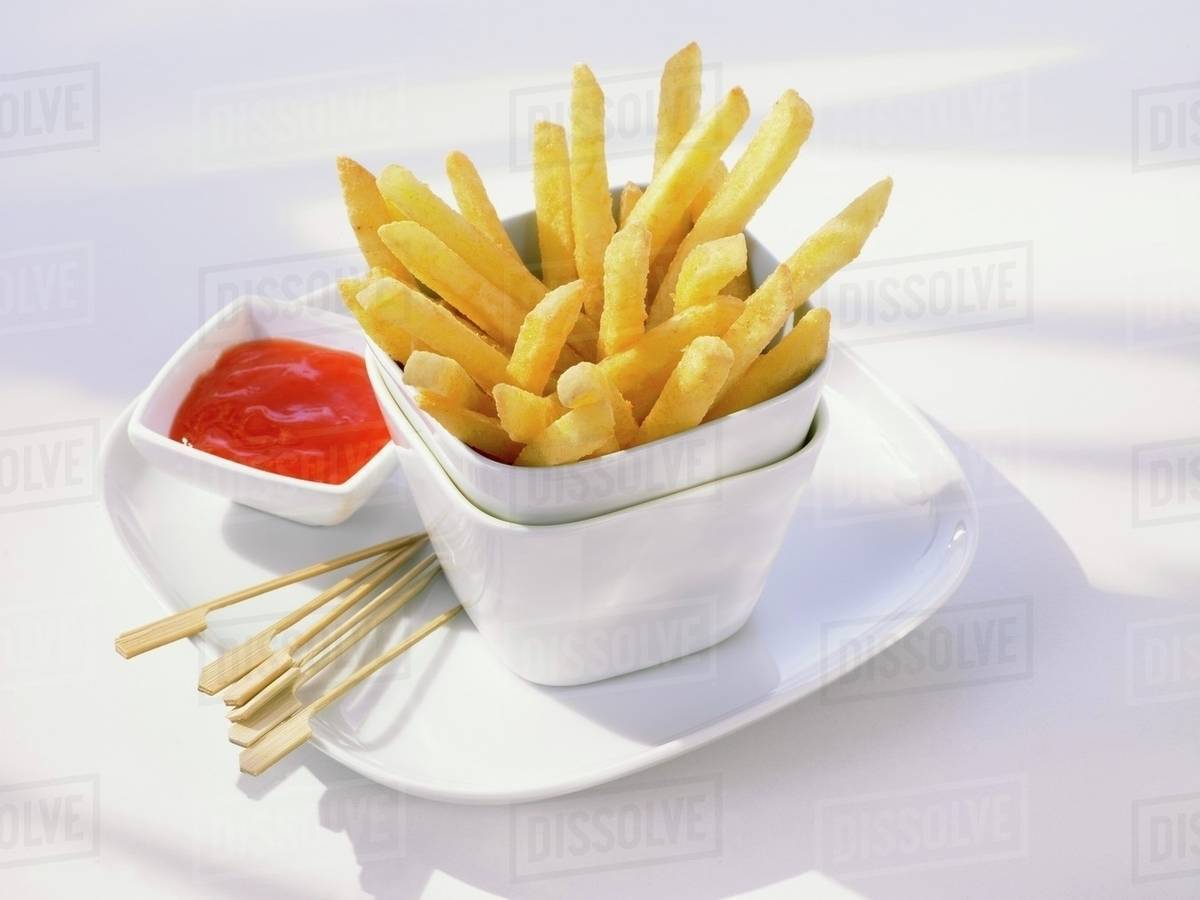 Chips in stacked pots with ketchup Stock Photo Dissolve