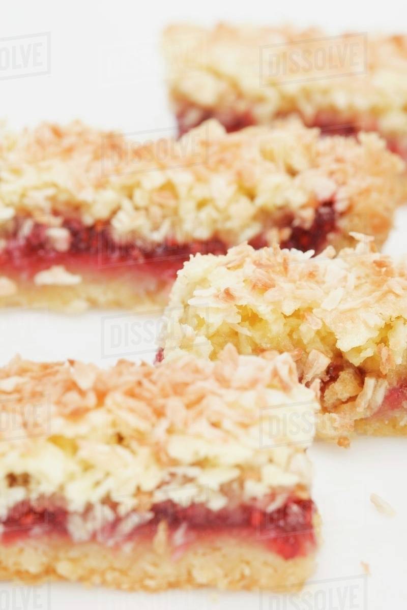 Coconut slices with raspberry jam filling Stock Photo Dissolve