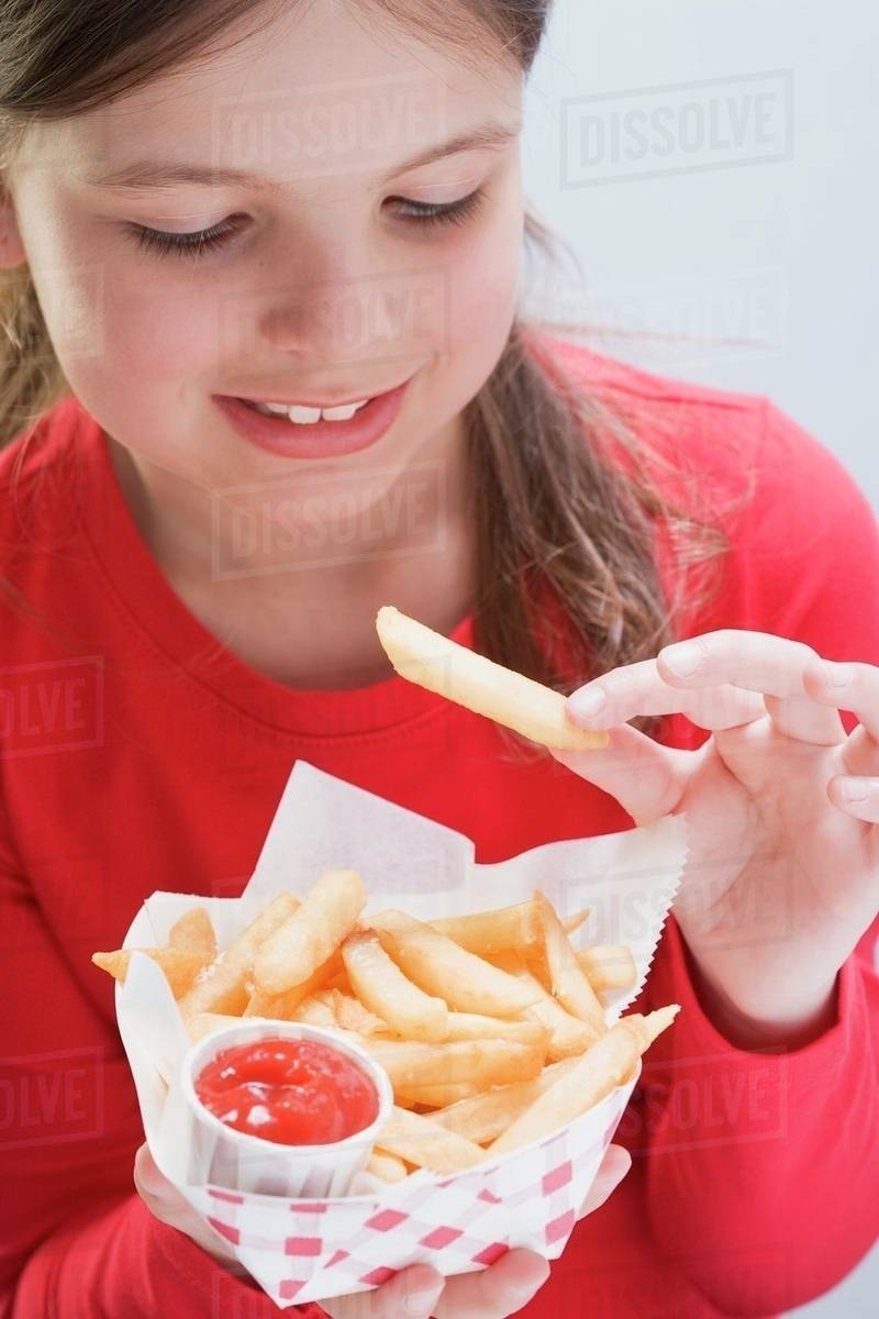Girl eating a bag of chips Stock Photo Dissolve