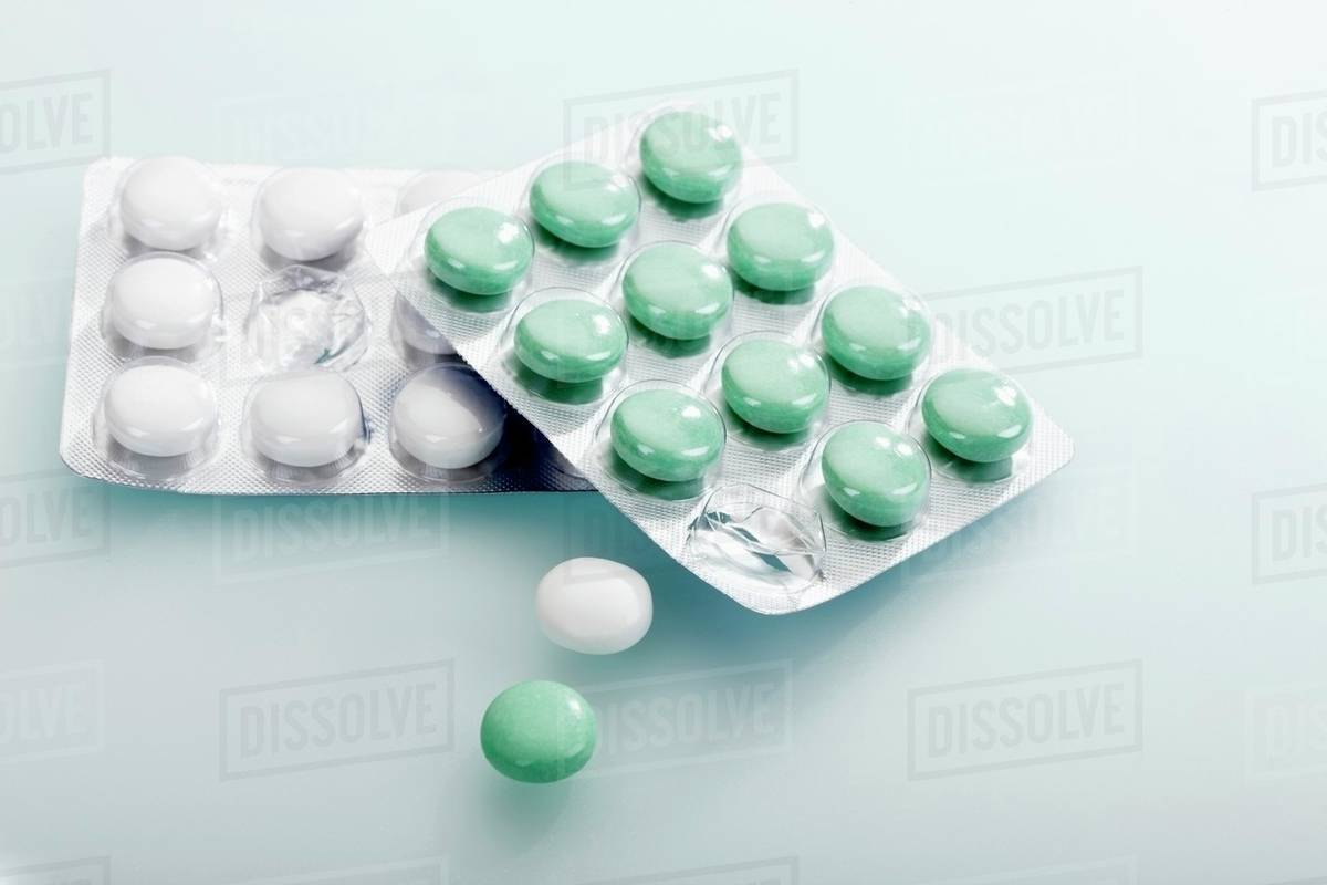 Chewing gum pellets in blister packs Stock Photo Dissolve