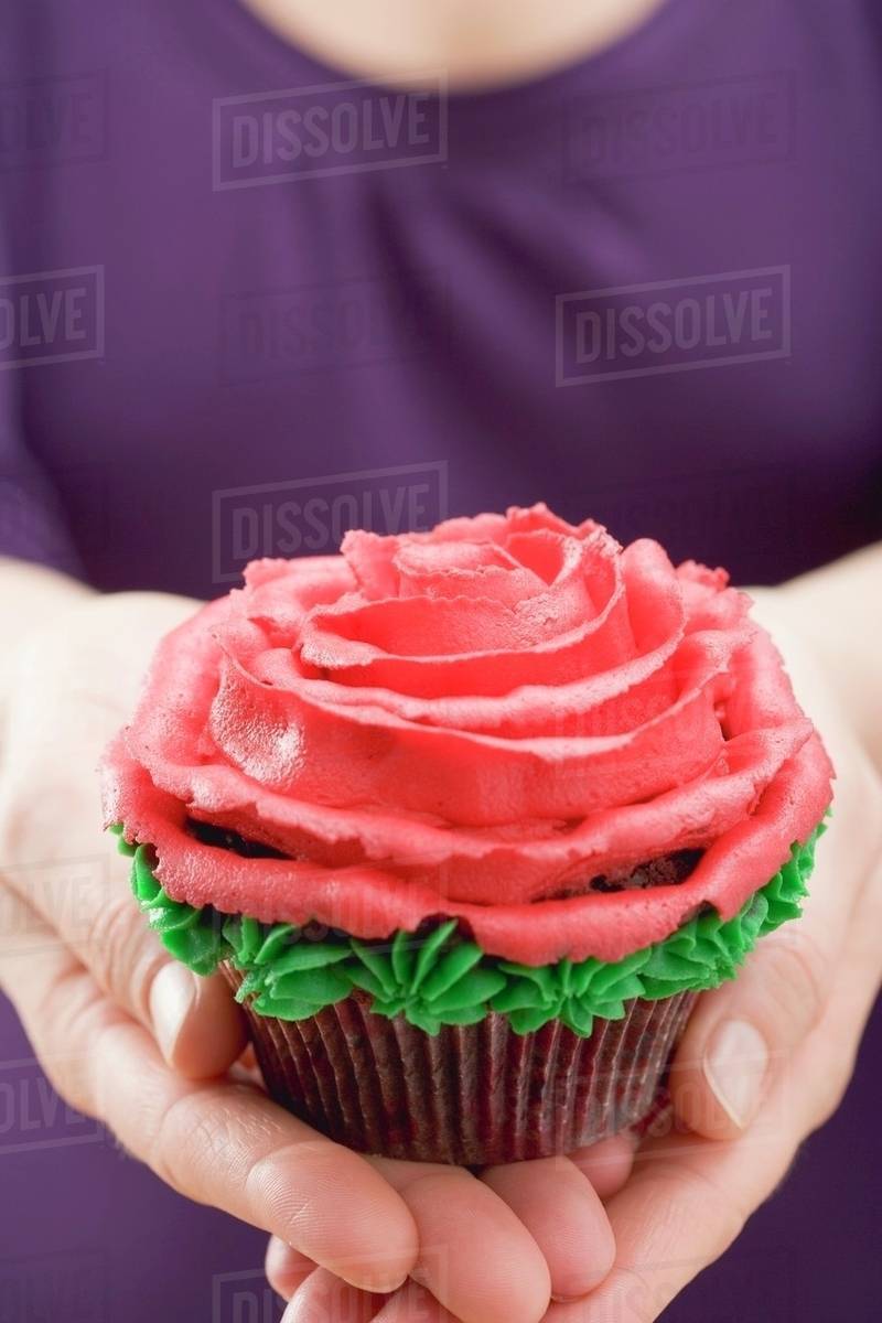 Woman holding cupcake Stock Photo Dissolve