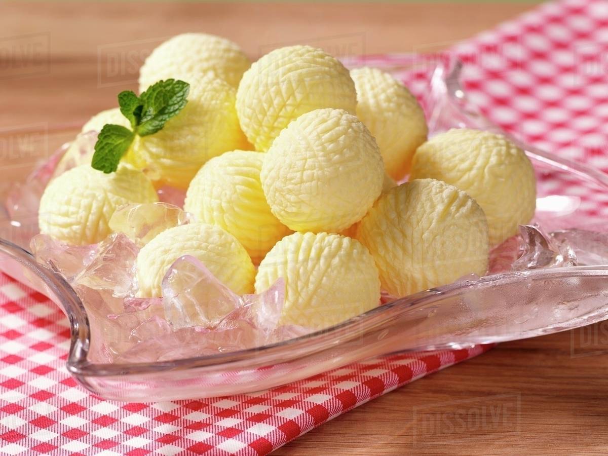 Butter balls on ice Stock Photo Dissolve