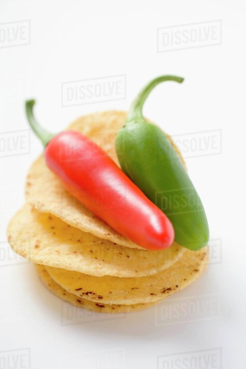 Tortilla chips with two Jalapeno chillies Stock Photo Dissolve