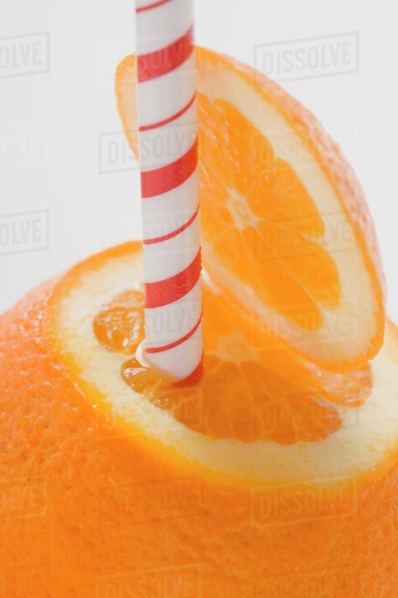 Orange with straw (closeup) Stock Photo Dissolve