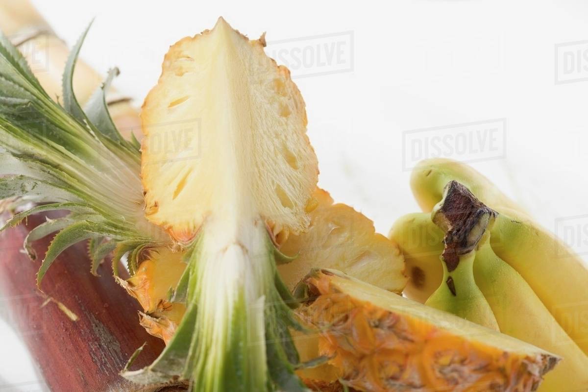 Pineapple, cut into pieces, and bananas Stock Photo Dissolve