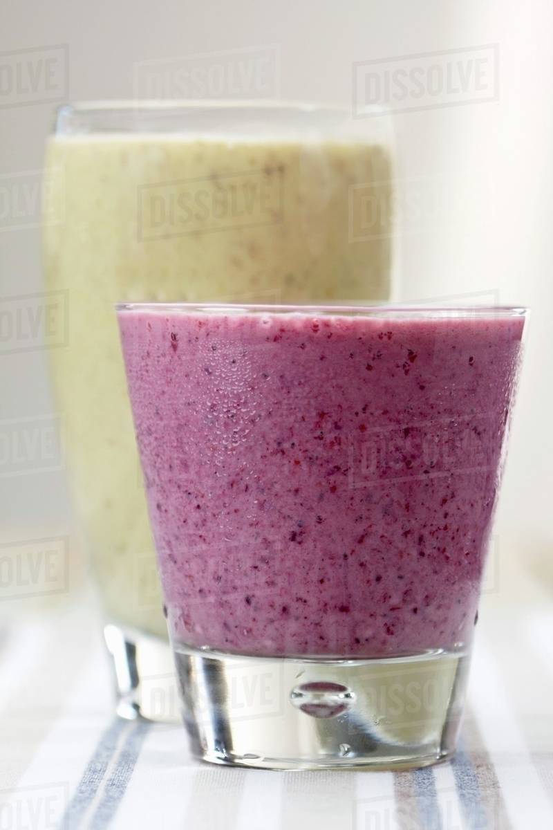 Peanut butter and banana smoothie and a berry smoothie Stock Photo