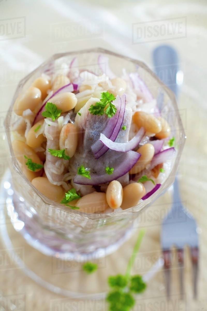 Herring salad with onions, beans and apples Stock Photo Dissolve