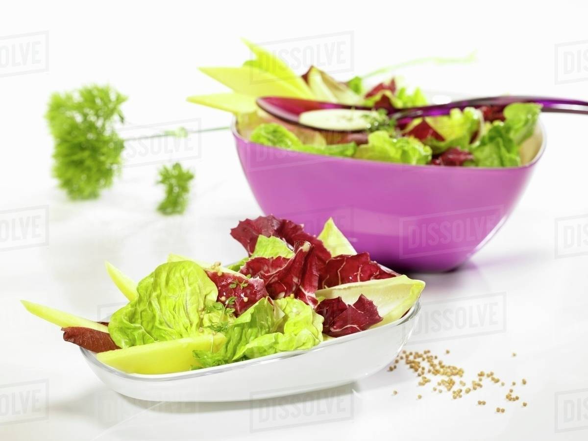 Mixed leaf salad with a mustard dressing Stock Photo Dissolve