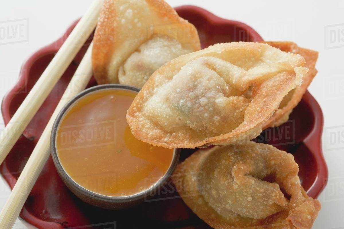 Deepfried dim sum with sweet & sour sauce (Asia) Stock Photo Dissolve