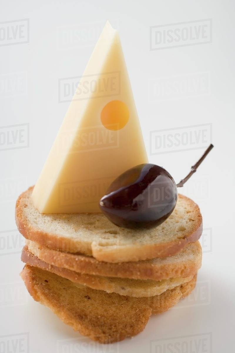 Emmental cheese and olive on slices of white bread Stock Photo Dissolve