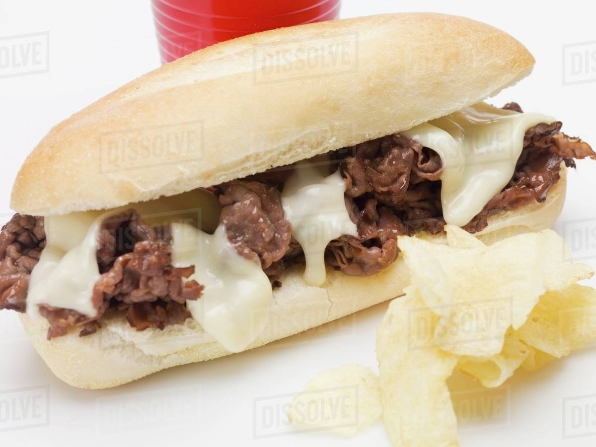 Shredded beef sandwich with melted cheese, crisps Stock Photo Dissolve
