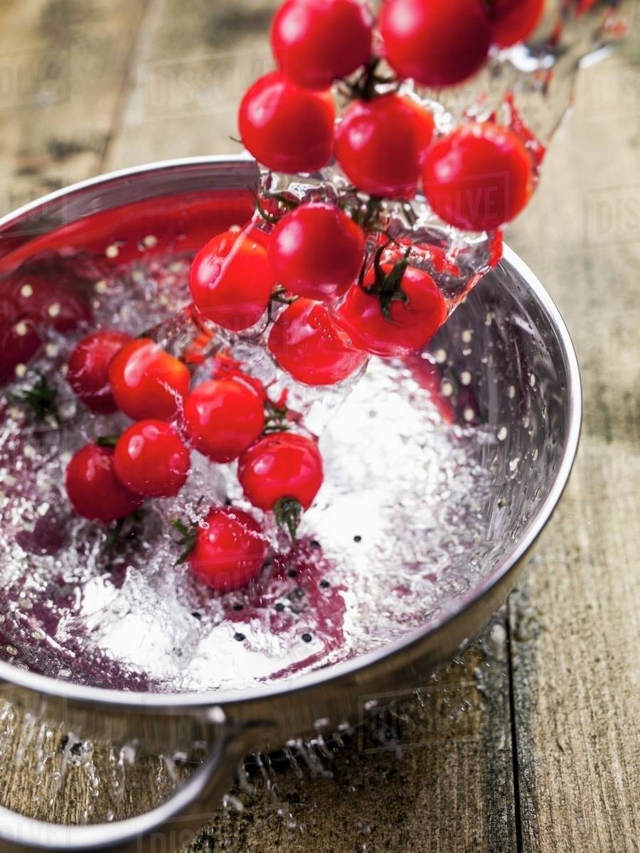 Tomatoes being drained Stock Photo Dissolve