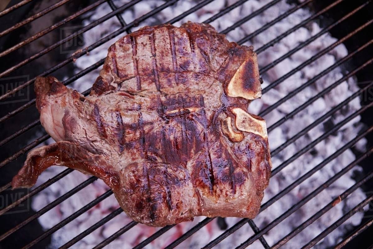 A Tbone steak on a barbecue Stock Photo Dissolve