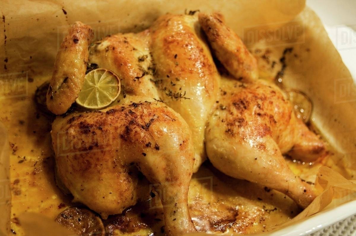 Flattened chicken with lime and thyme Stock Photo Dissolve