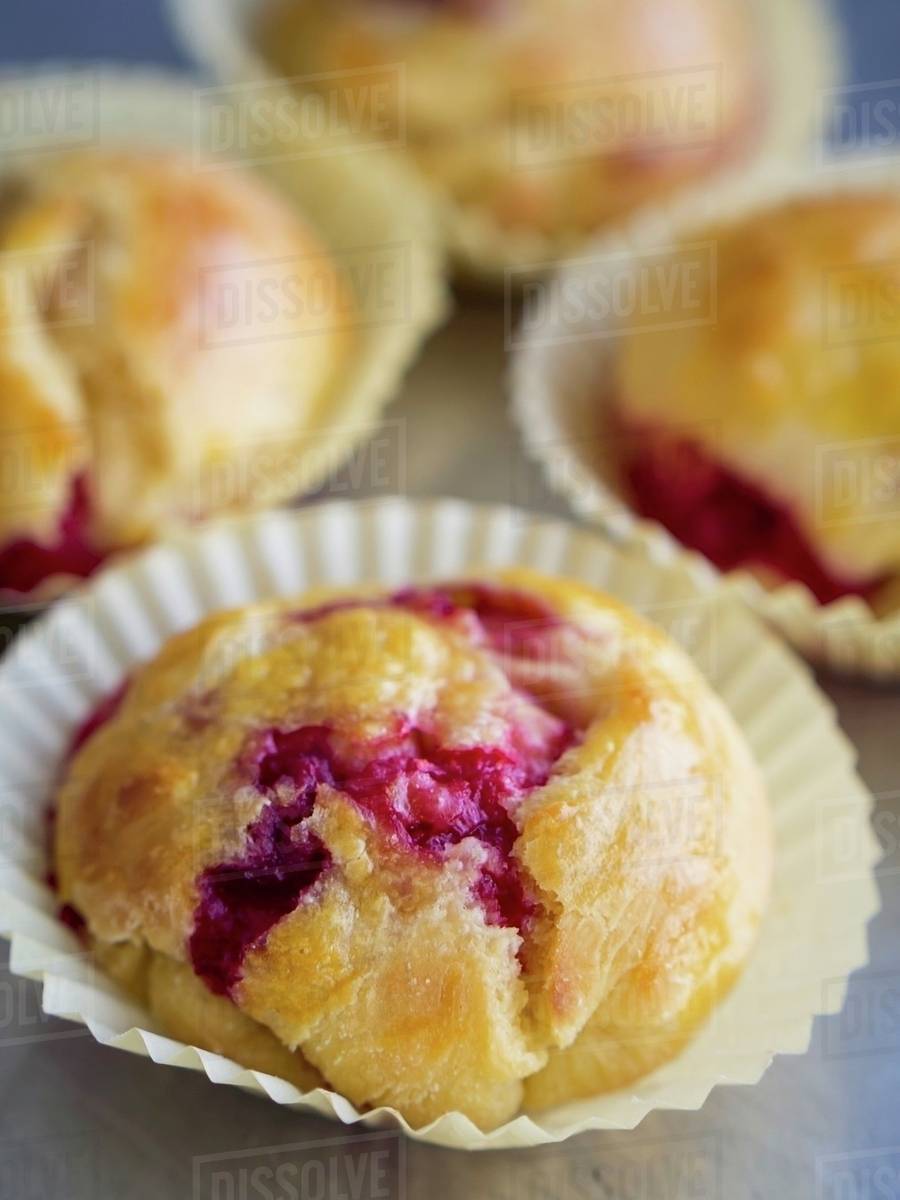 Mini yeast cakes with raspberries Stock Photo Dissolve
