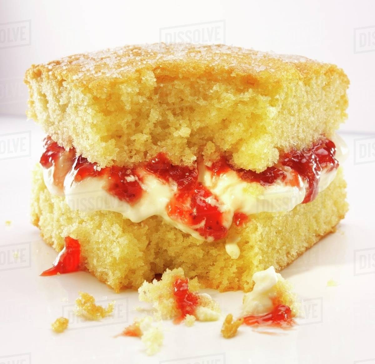 A slice of Victoria Sponge Cake with a bite take out Stock Photo