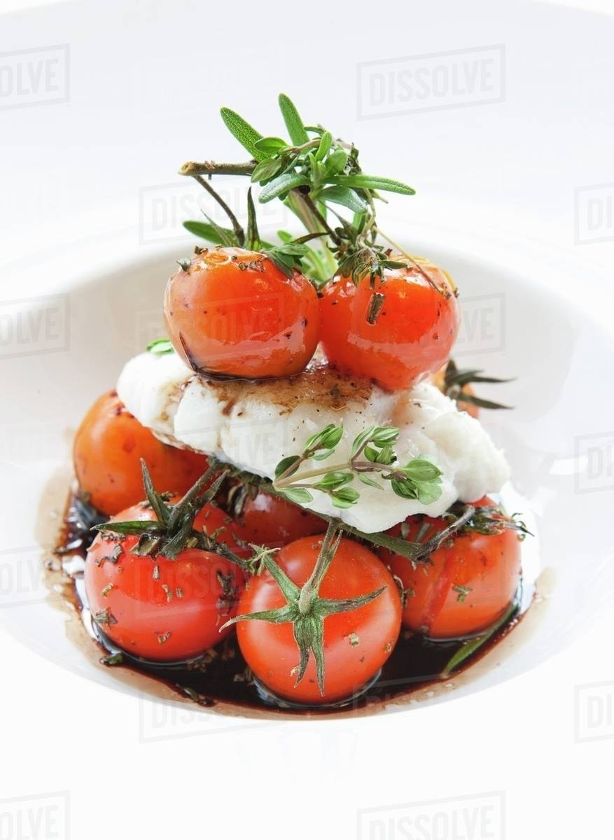 Cod with baked cherry tomatoes in a balsamic sauce - Stock Photo - Dissolve