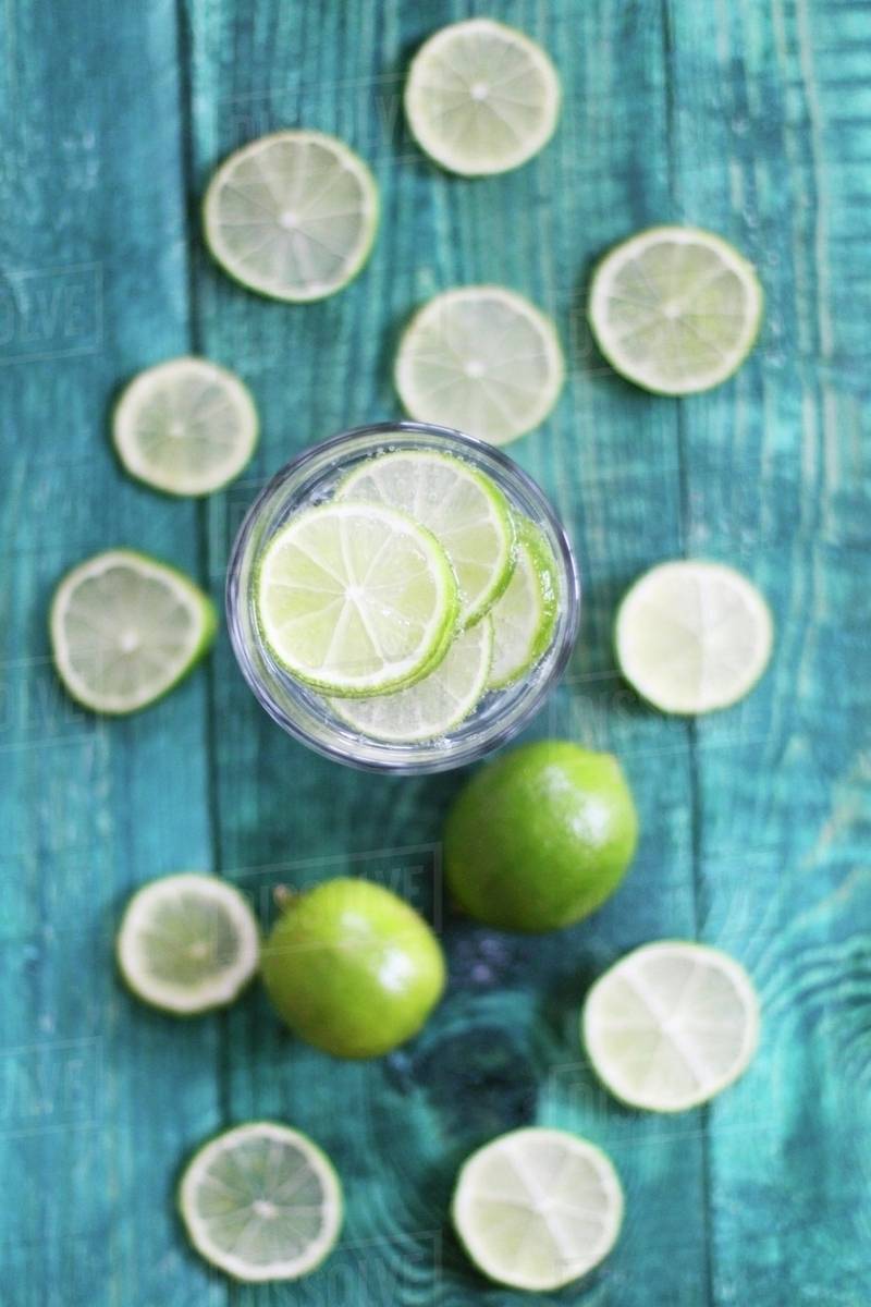 A glass of water with lots of limes Stock Photo Dissolve