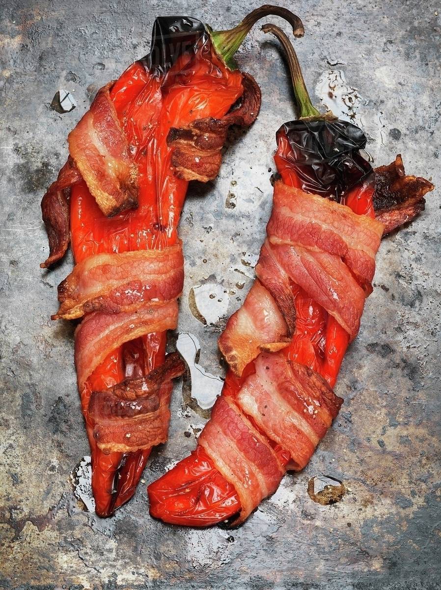 Grilled red peppers wrapped in bacon (seen from above) Stock Photo Dissolve