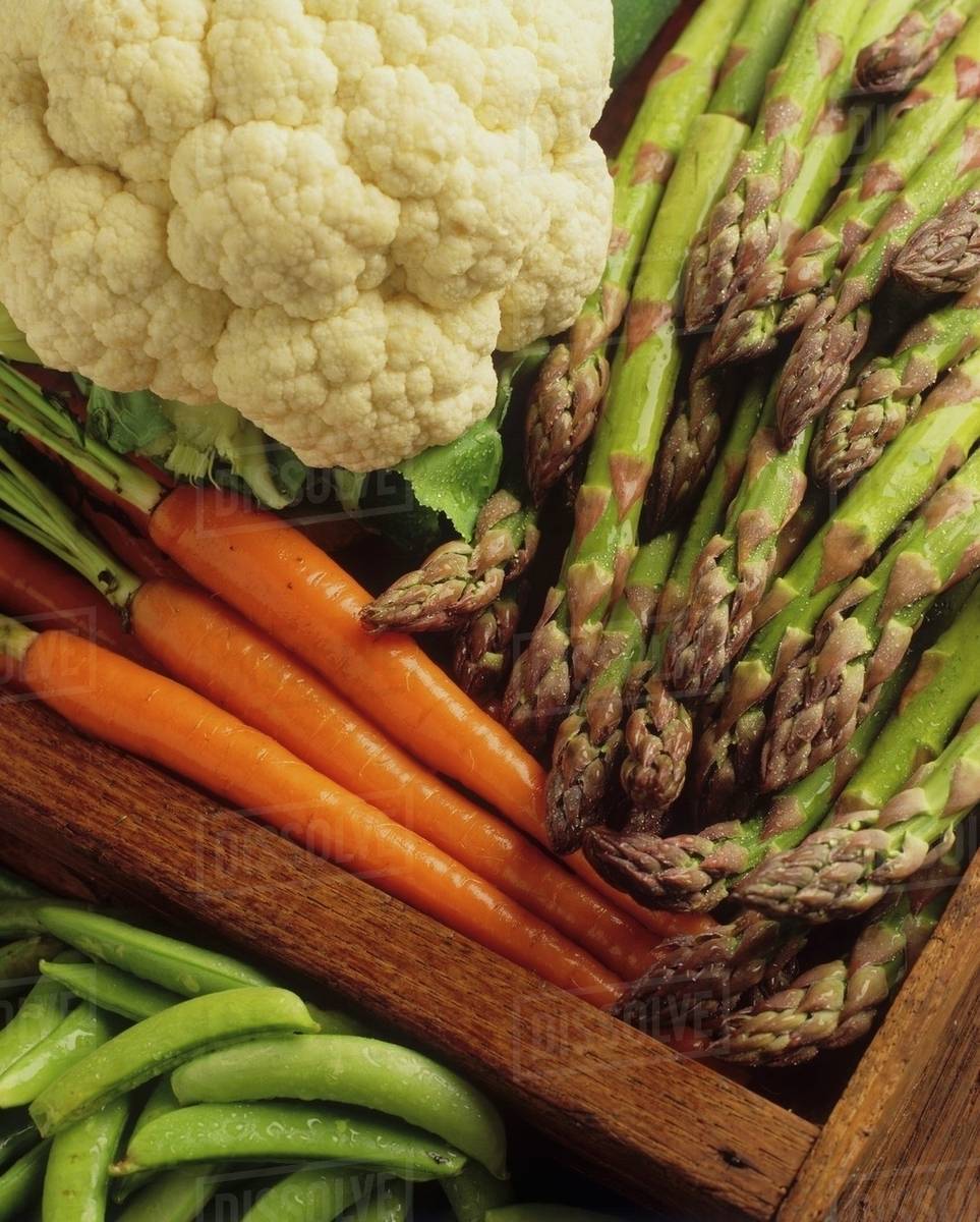 Various types of vegetables in a crate (closeup) Stock Photo Dissolve