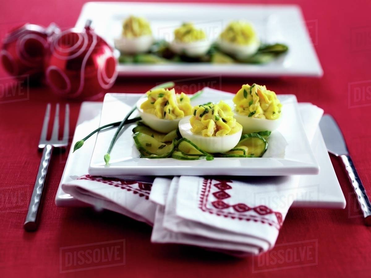 Devilled eggs on cucumber slices Stock Photo Dissolve