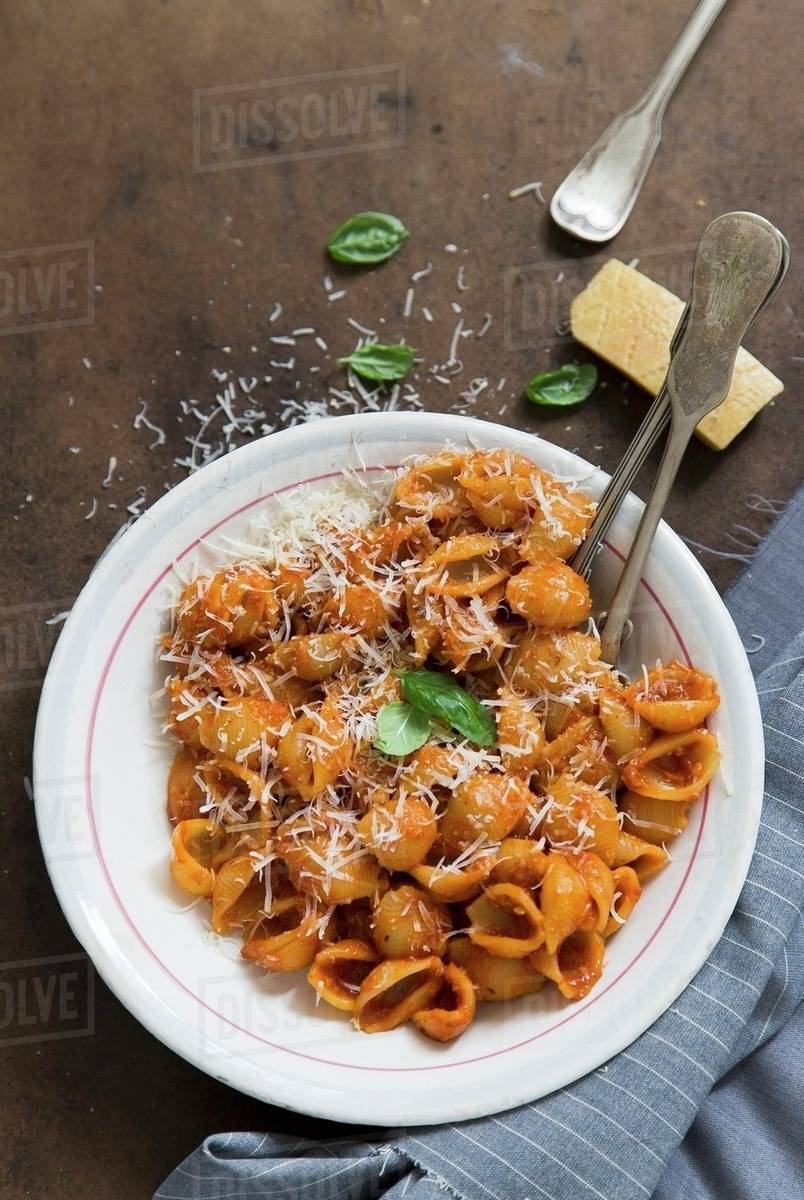 Shell pasta with tomato sauce and Parmesan cheese Stock Photo Dissolve
