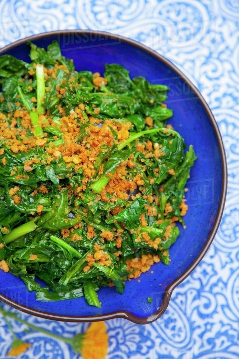 Spinach with crispy crumbs Stock Photo Dissolve