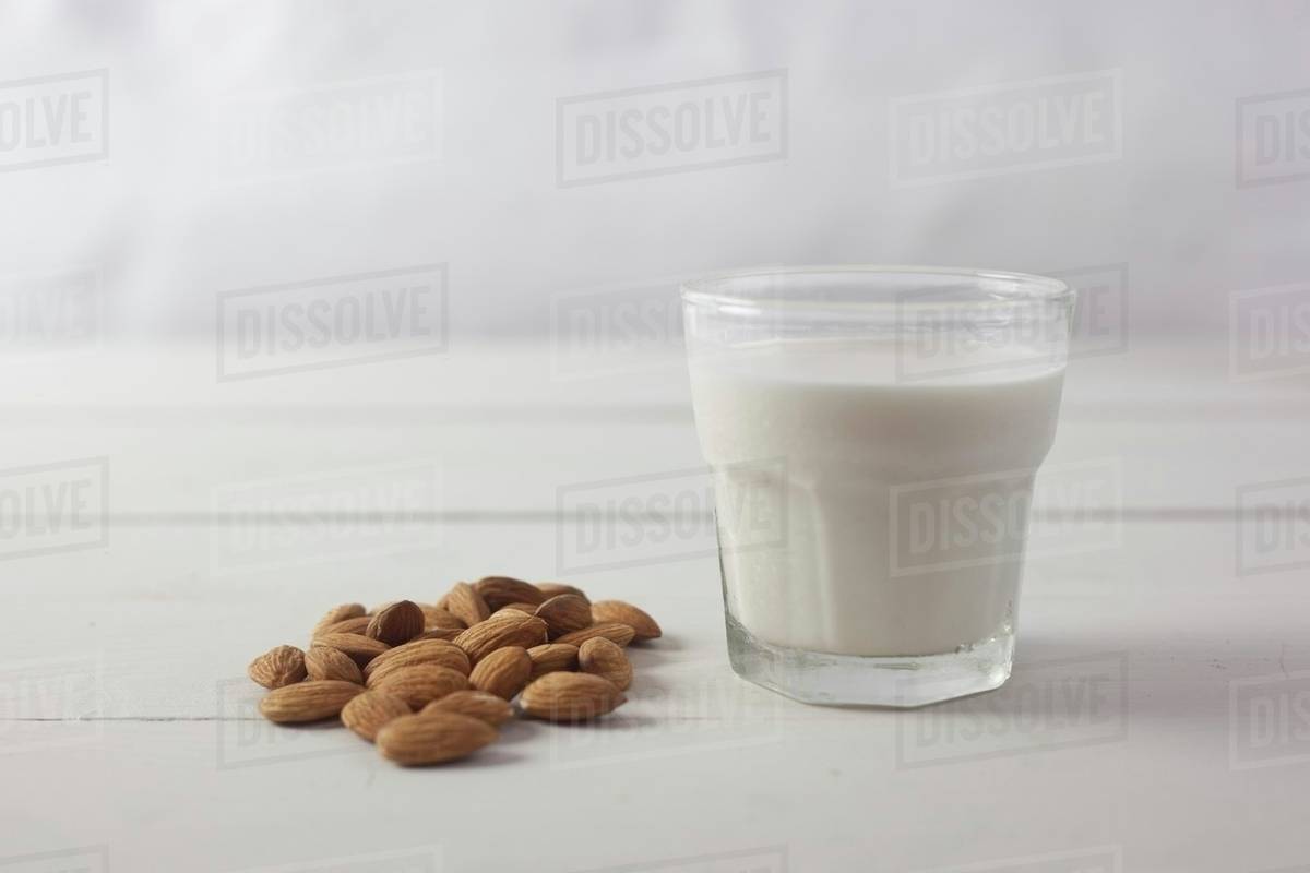Almonds and a glass of almond milk Stock Photo Dissolve