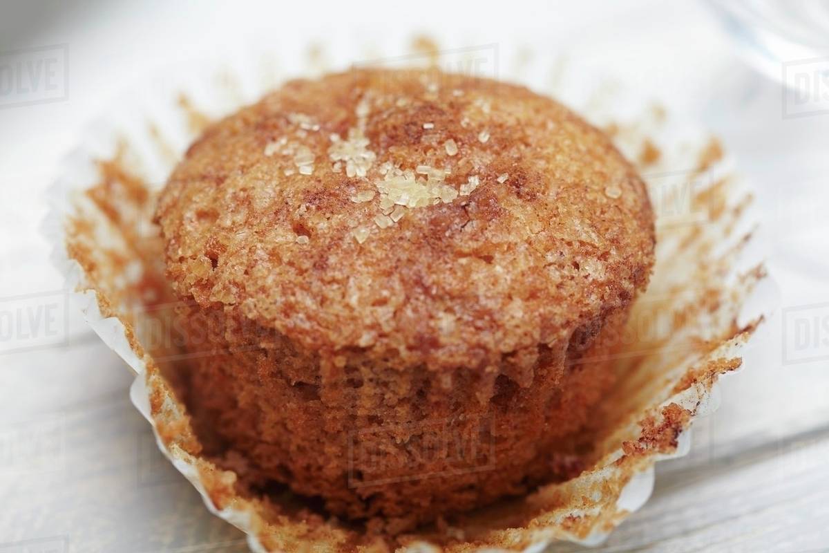 A Cinnamon Sugar Muffin with Wrapper Peeled Away Stock Photo Dissolve