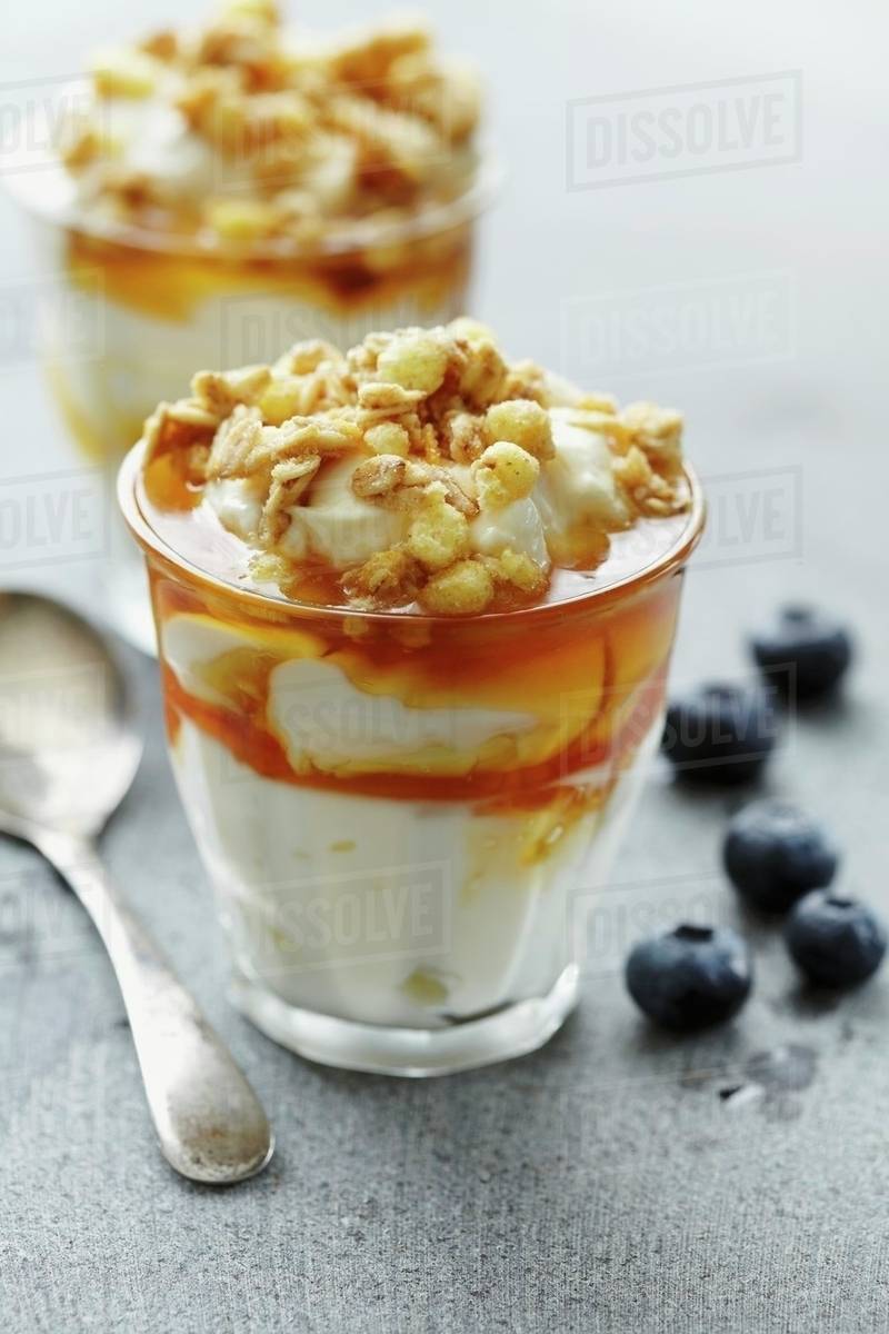 Yoghurt with honey and muesli Stock Photo Dissolve