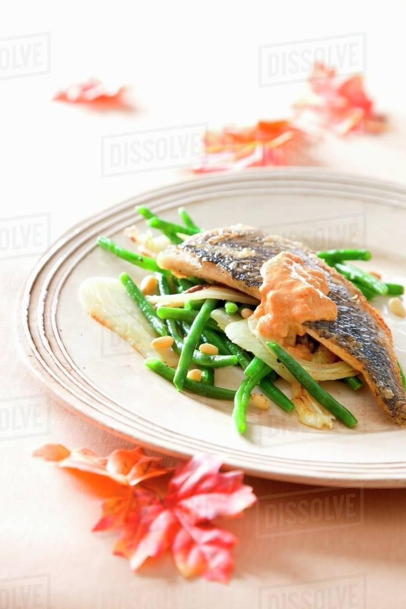 Sea bass with green beans and tomato sauce Stock Photo Dissolve