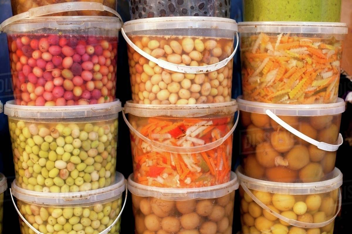 Pickled vegetables in plastic buckets at the market Stock Photo