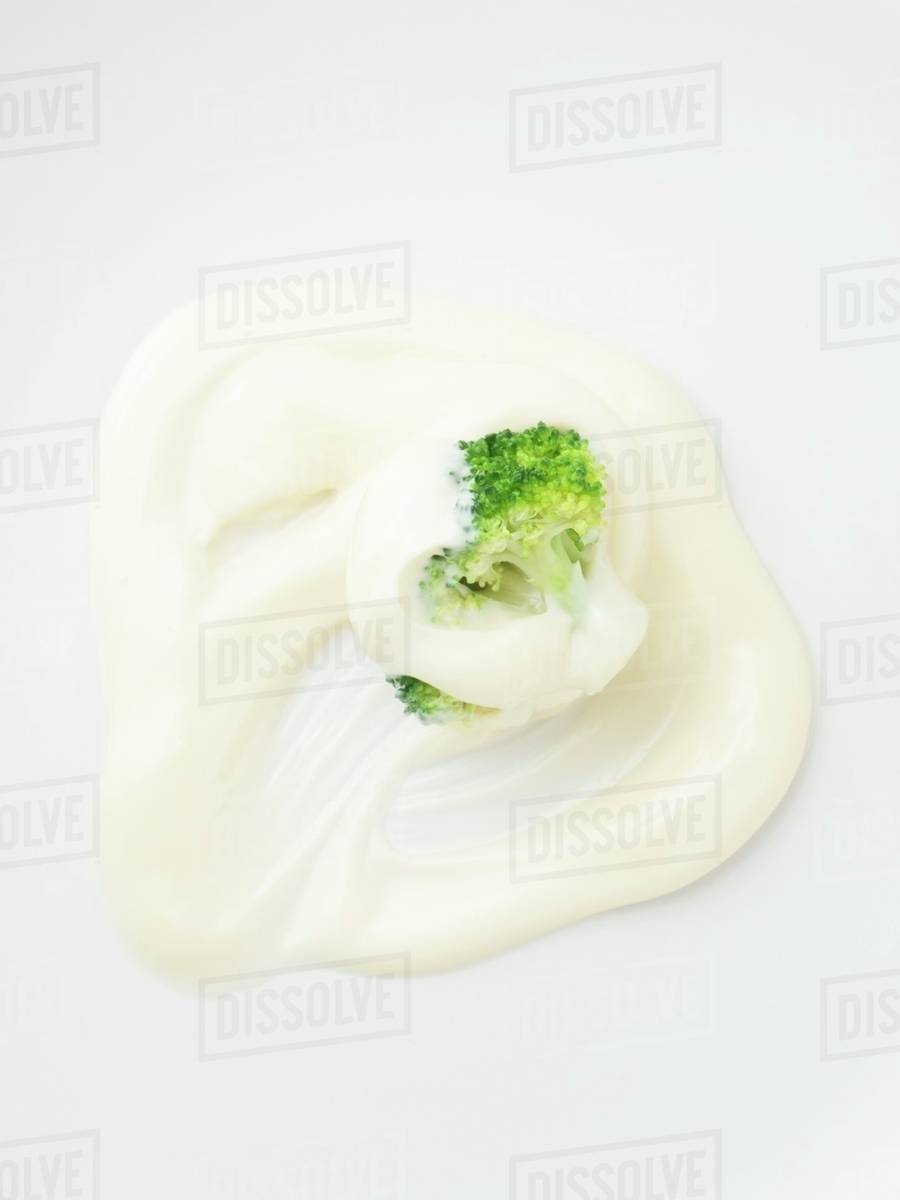 Cooked broccoli with mayonnaise Stock Photo Dissolve