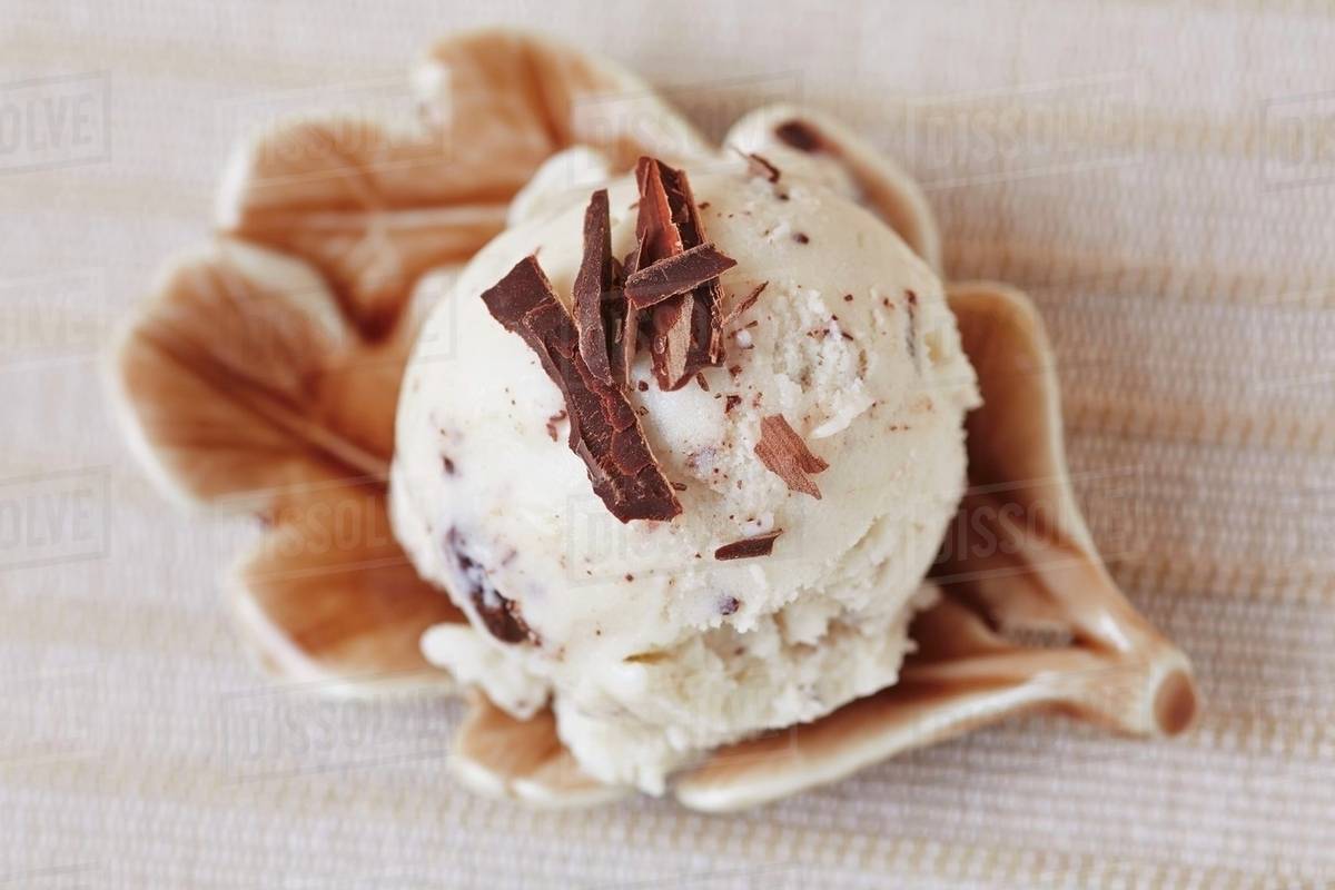 A scoop of homemade stracciatella ice cream with grated chocolate