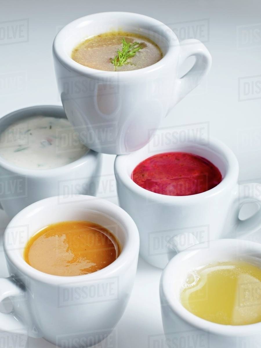 Various soups in espresso cups Stock Photo Dissolve