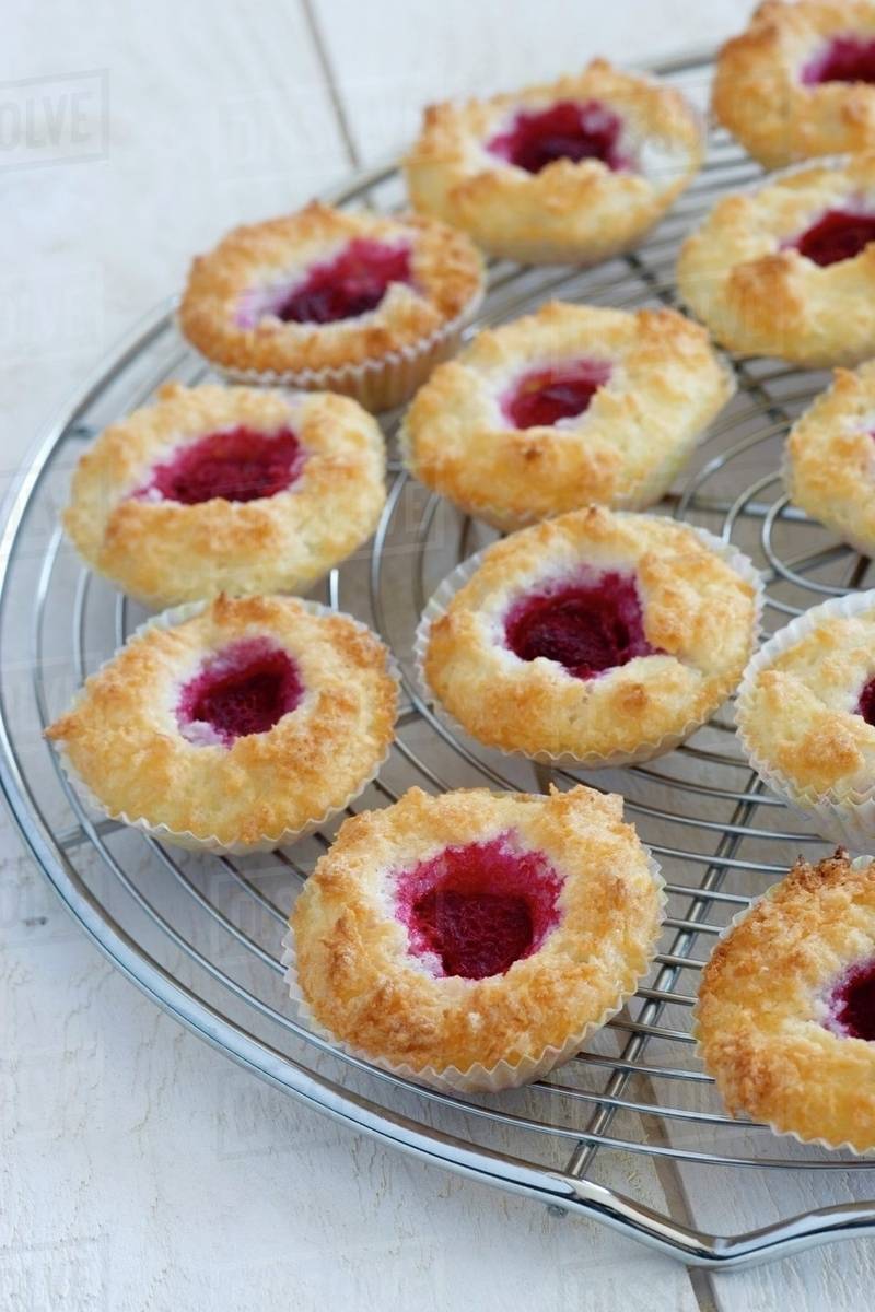 Coconut macaroons with raspberry jam on a wire rack Stock Photo