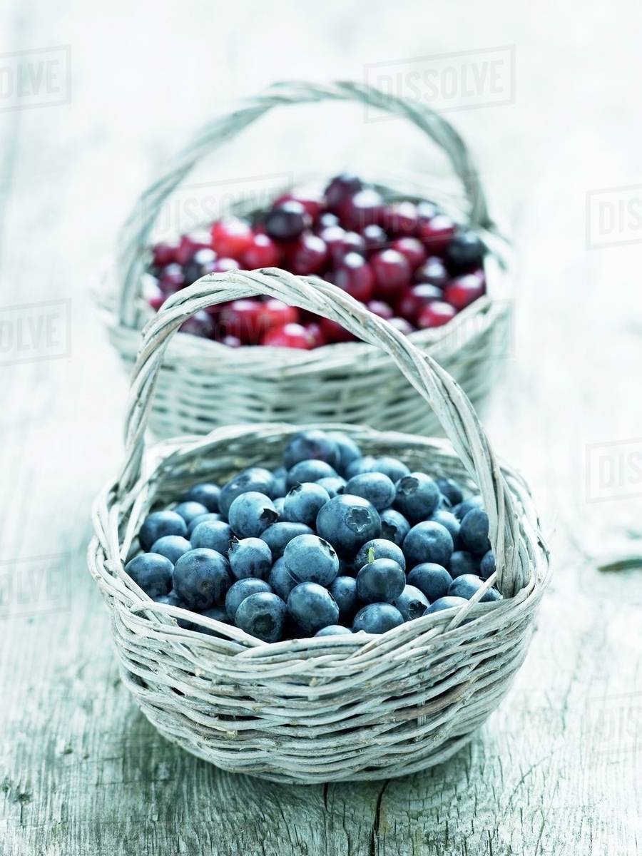 Blueberries and cranberries in baskets Stock Photo Dissolve