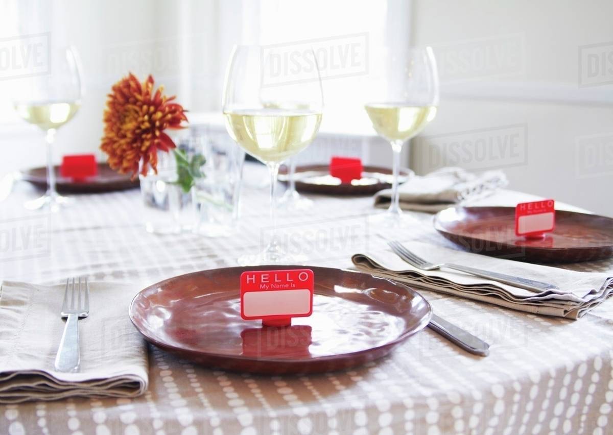 table set with name tag place settings white wine stock photo