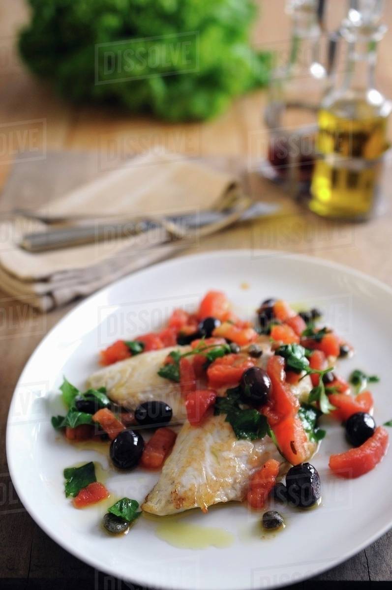 Pan fried fillets of John Dory with baby plum tomatoes and black olives