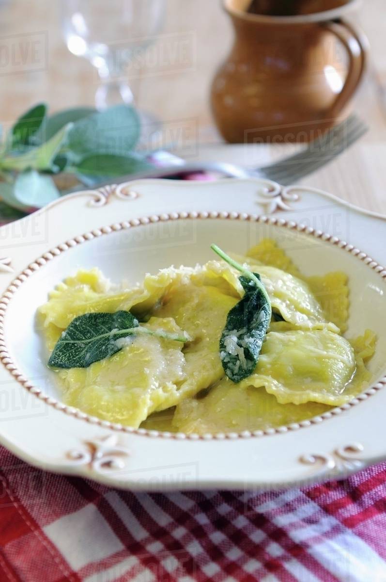 Spinach and ricotta filled ravioli with sage butter Stock Photo