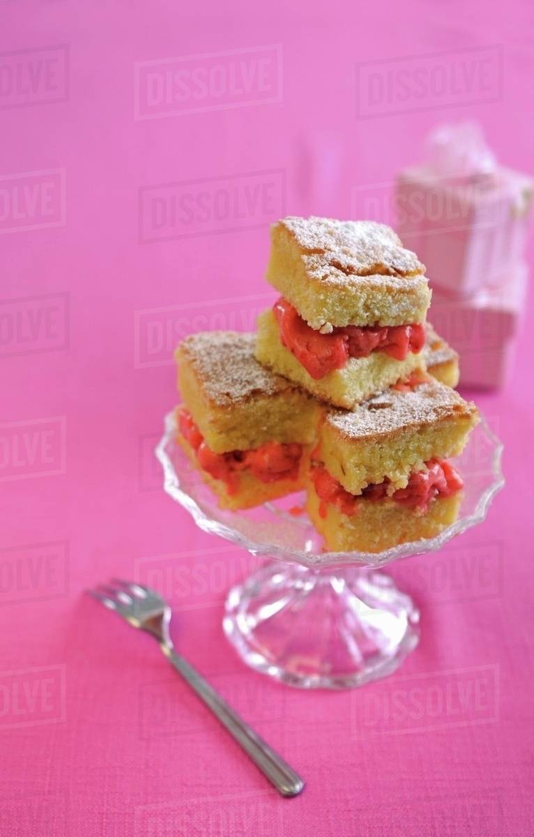 An ice cream sandwich made with lemon cake and strawberry ice cream Stock Photo Dissolve