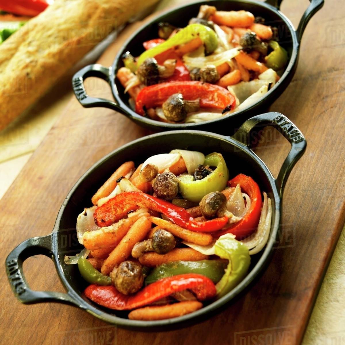 Mixed Roasted Vegetables in Cast Iron Skillets Stock Photo Dissolve