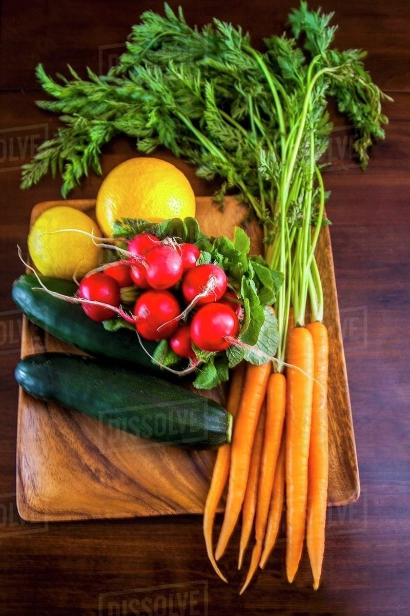 Fresh Whole Vegetables on a Cutting Board Stock Photo Dissolve