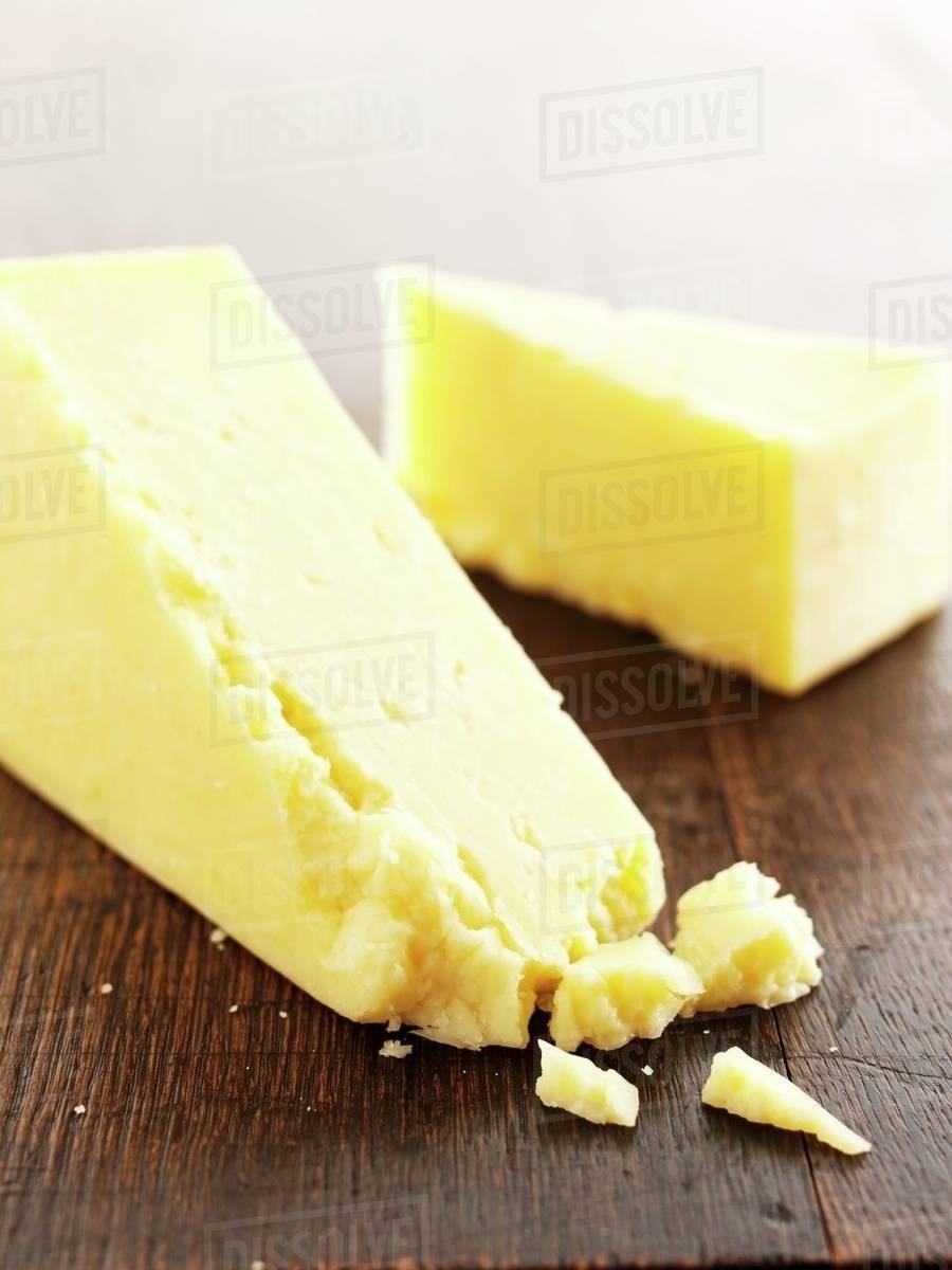Slices of Cheddar cheese Stock Photo Dissolve