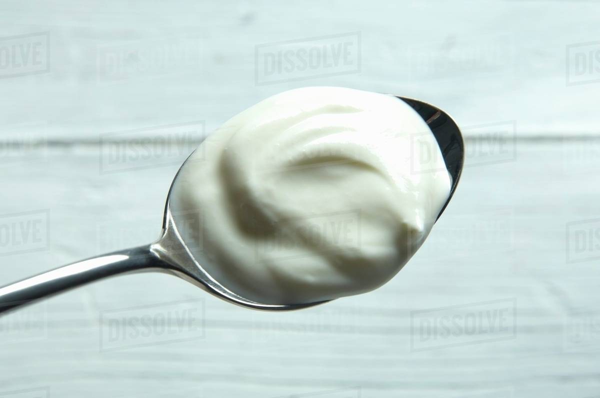 A spoonful of yogurt Stock Photo Dissolve