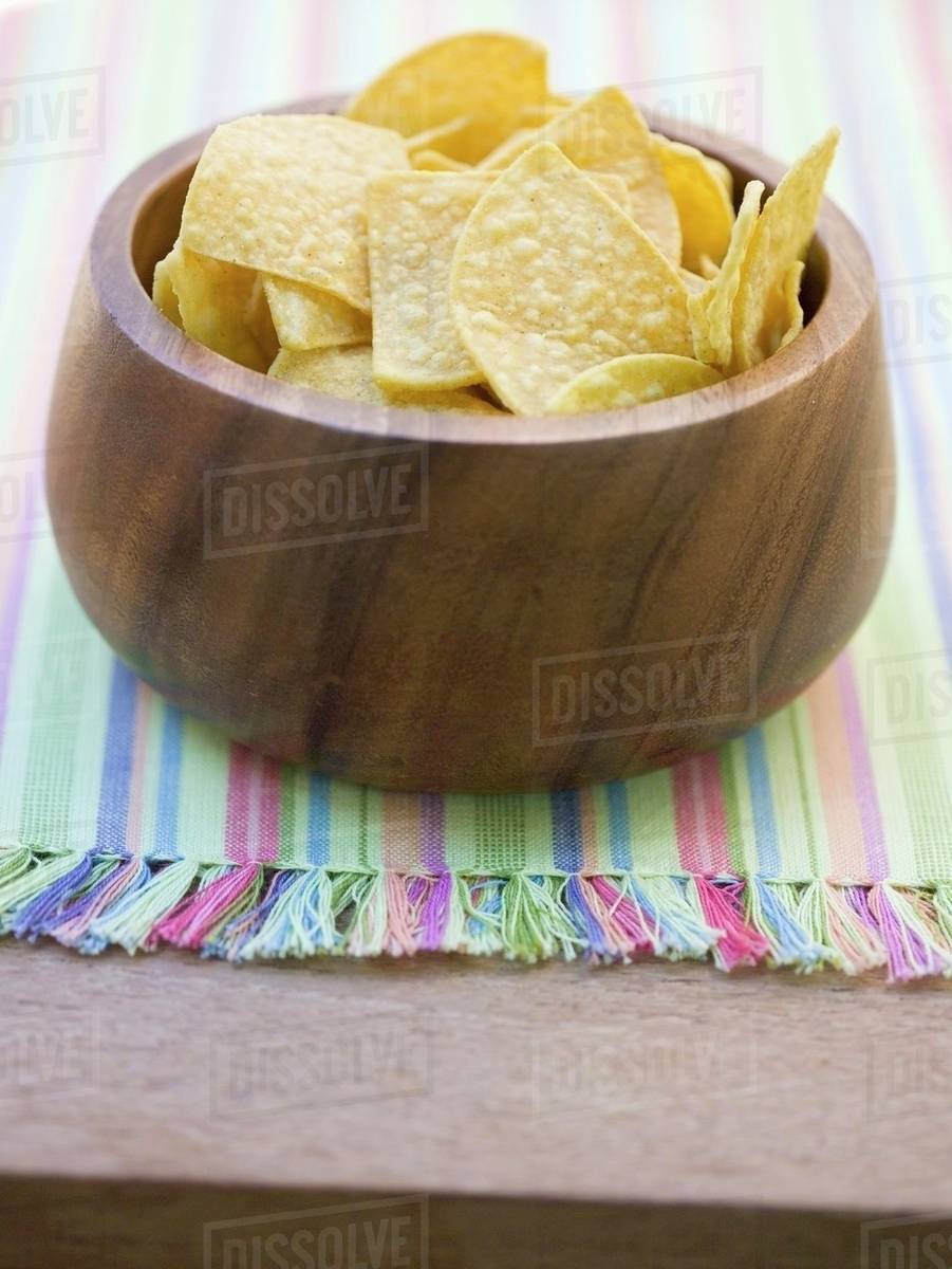 Tortilla chips in wooden bowl Stock Photo Dissolve